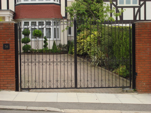 Decorated cast iron double driveway gates. These gates have small detailed patterns.