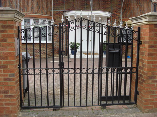 Secure pedestrian driveway gate with intercom system to gain access.  There is a door in the middle and a letter box secure.