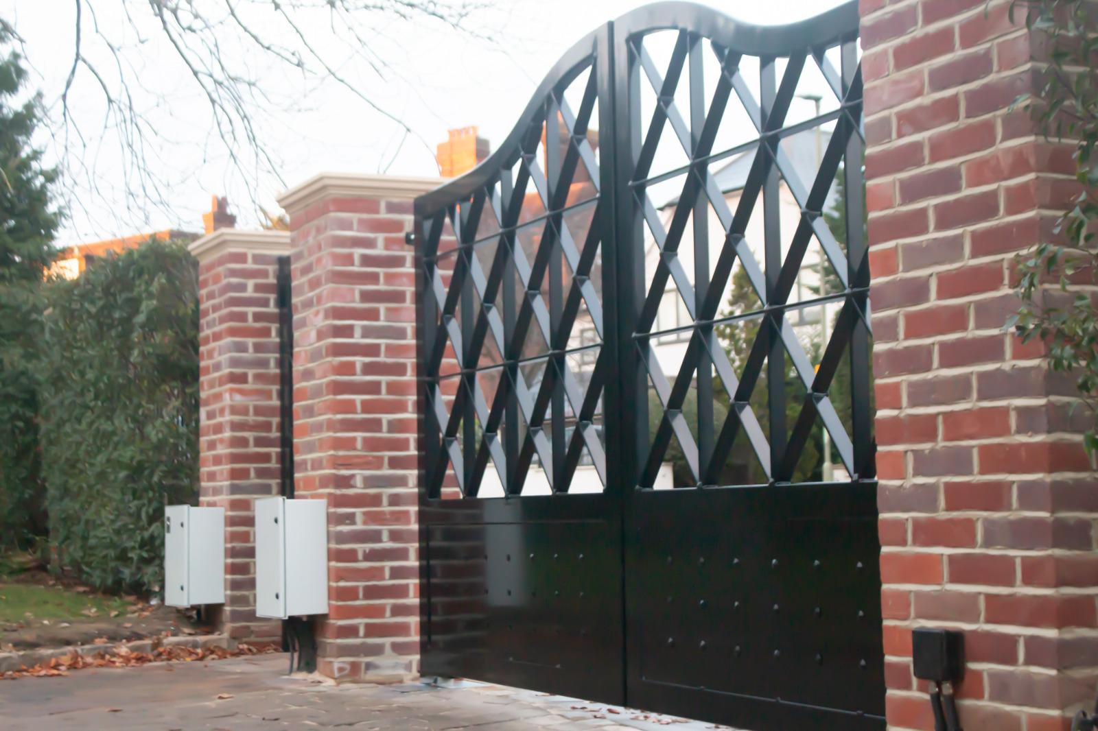 Green painted double wooden electric gatess